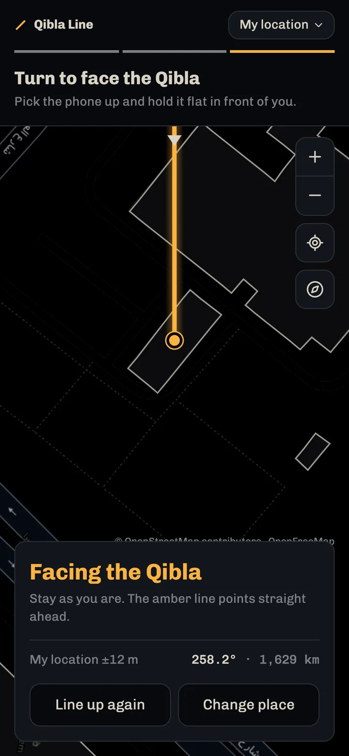 The Face screen: the amber line points straight up and the card reads Facing the Qibla